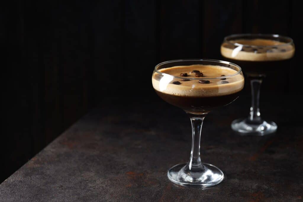 Espresso martini cocktail, delicious alcohol drink, space for text